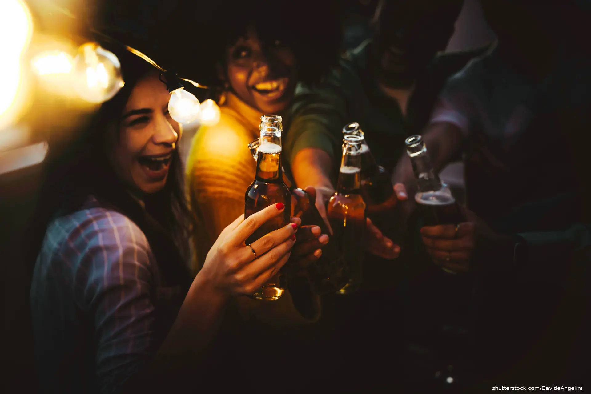 five youths holding beer bottles
