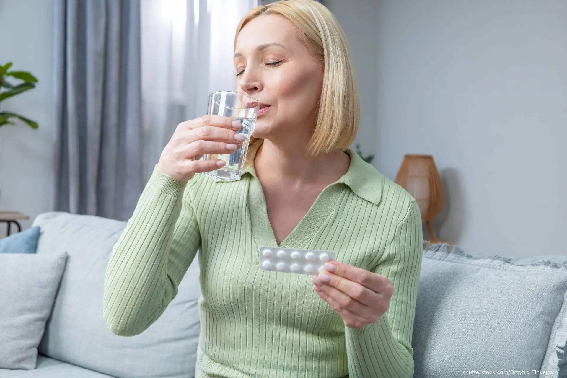 Blonde woman in her 50s taking hormone replacement pills