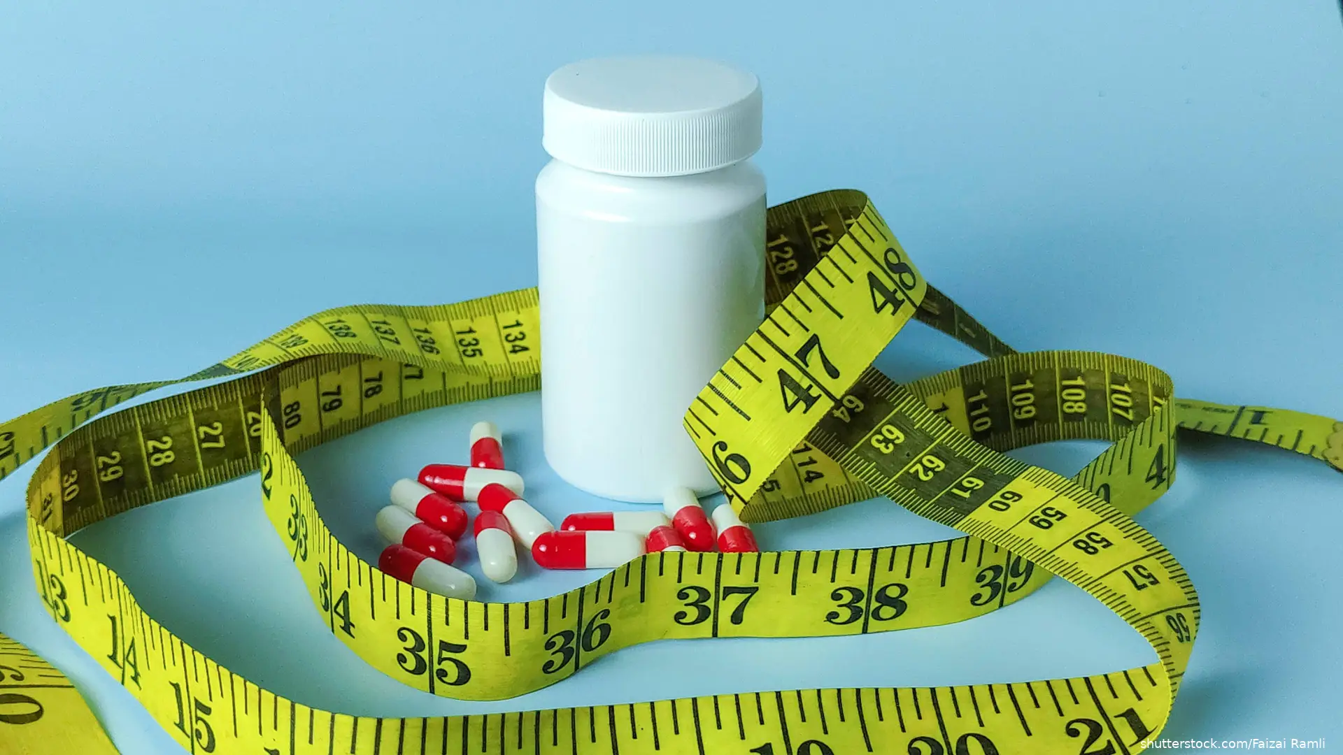 White Pill Bottle with Capsules and Yellow Measuring Tape