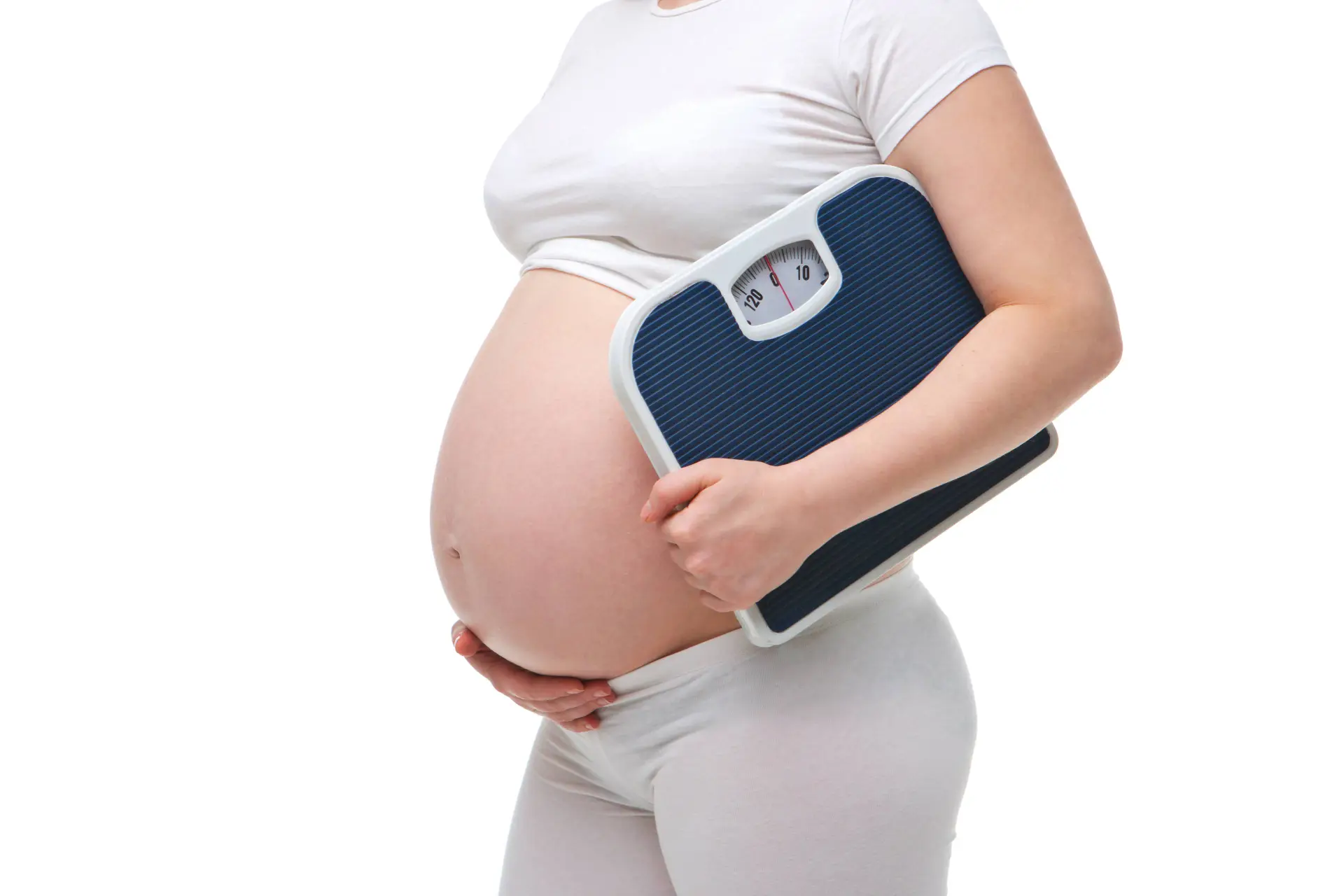 pregnant woman on white background holding scale shutterstock_399989494