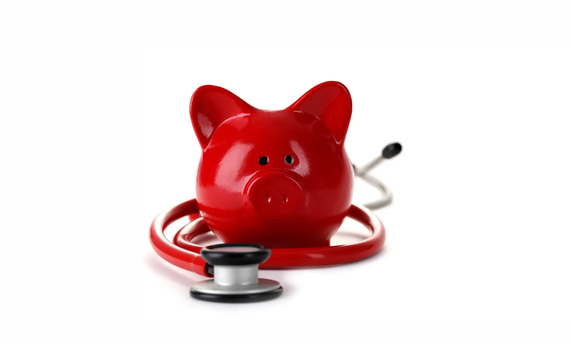 Red piggy bank with stethoscope isolated on white background