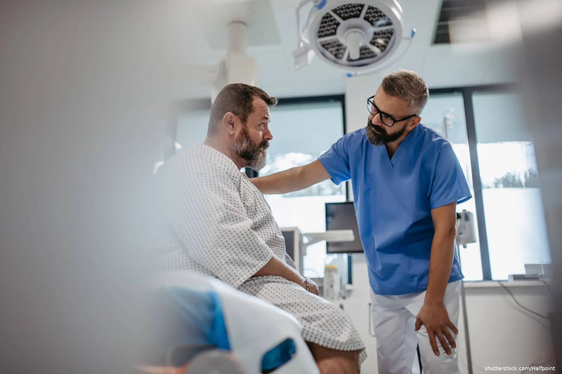 doctor comforting patient in hospital room