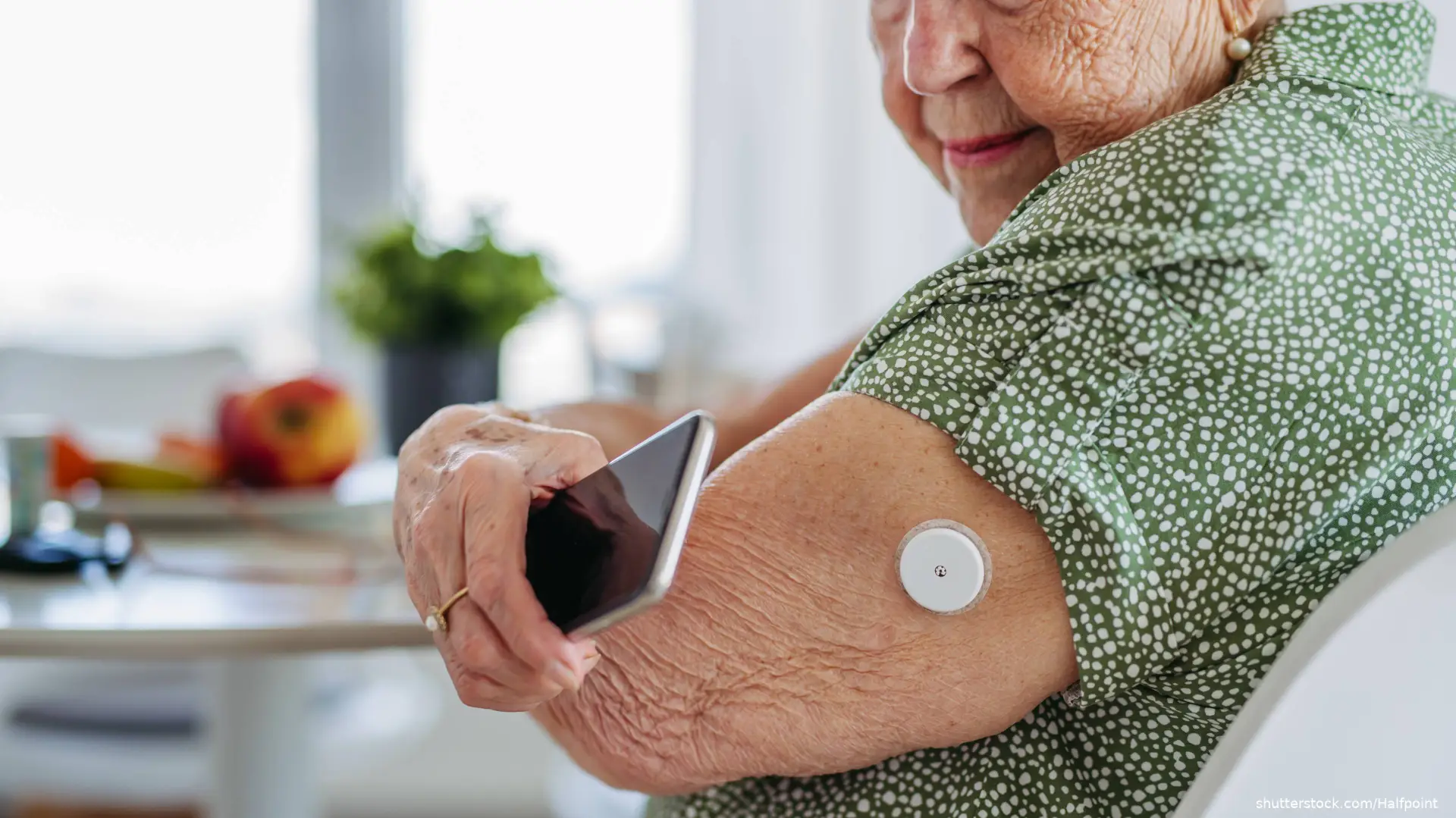 woman using continuous glucose monitor
