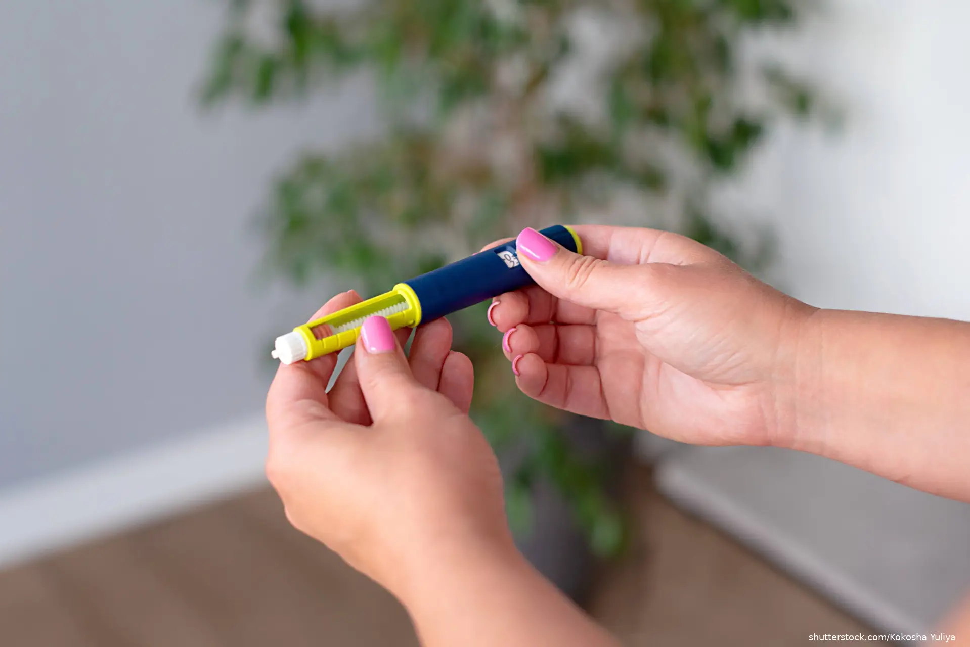 Woman holding an injection pen for diabetic. Insulin injection