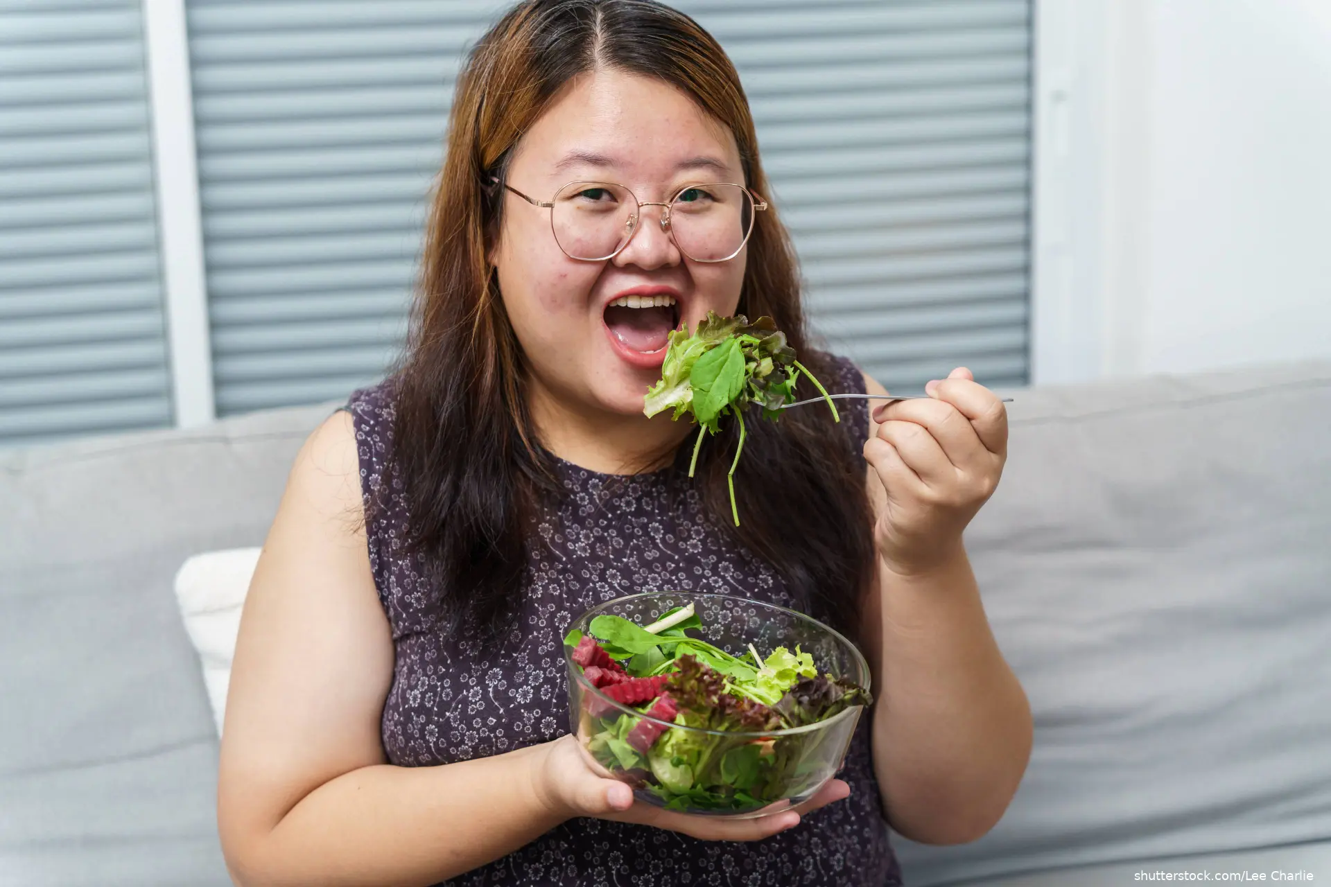 overweight woman eating salad