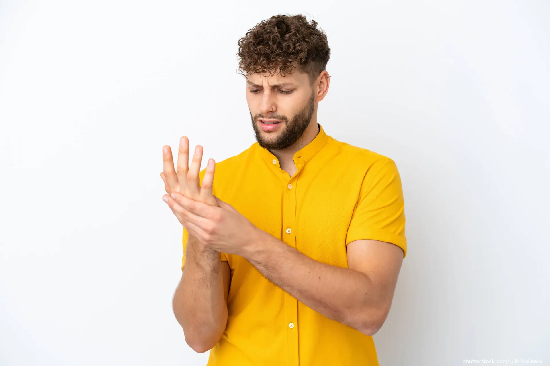 Young handsome caucasian man isolated on white background suffering from arthritis