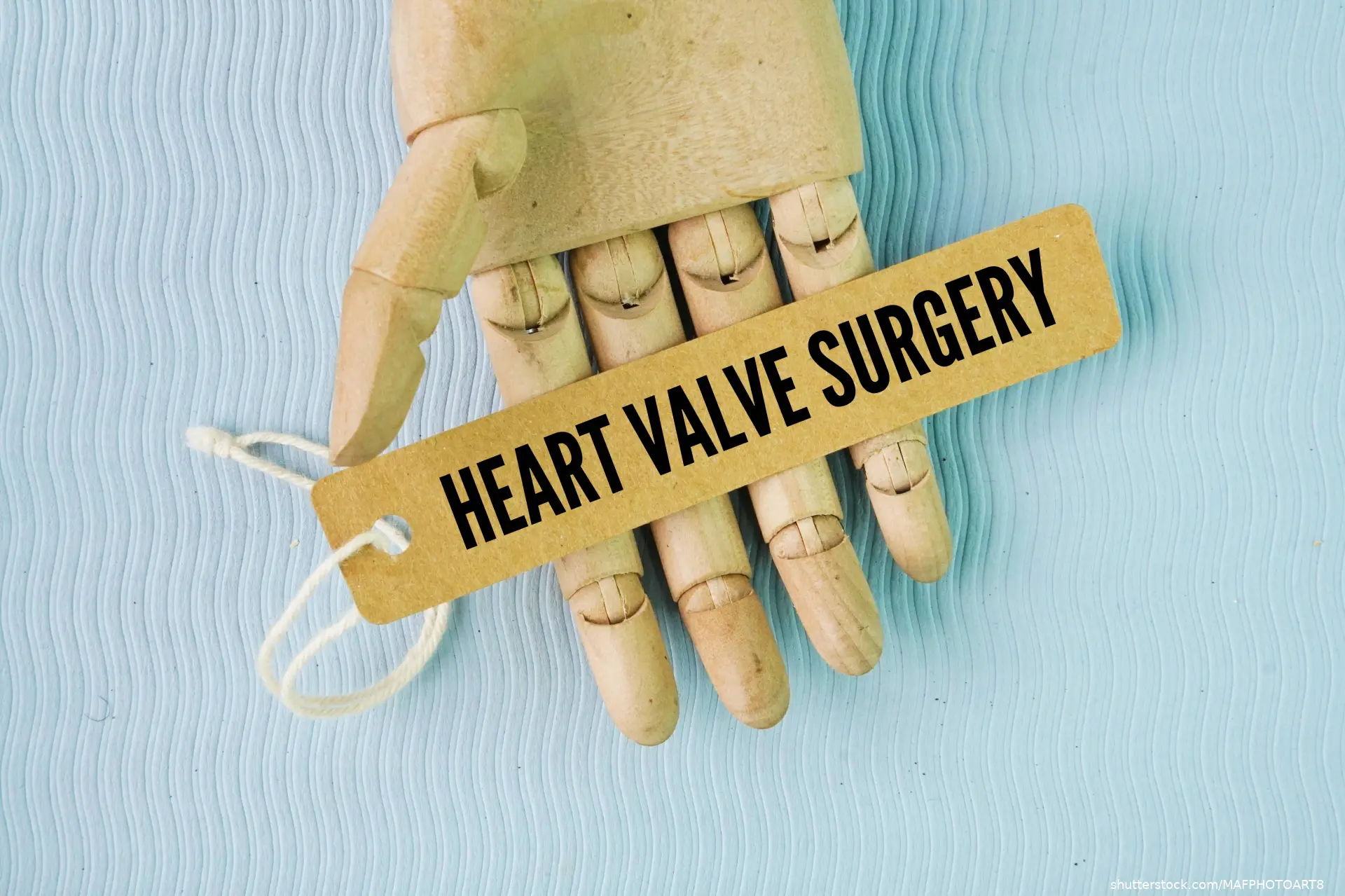 fake hand hold tag that reads heart valve surgery