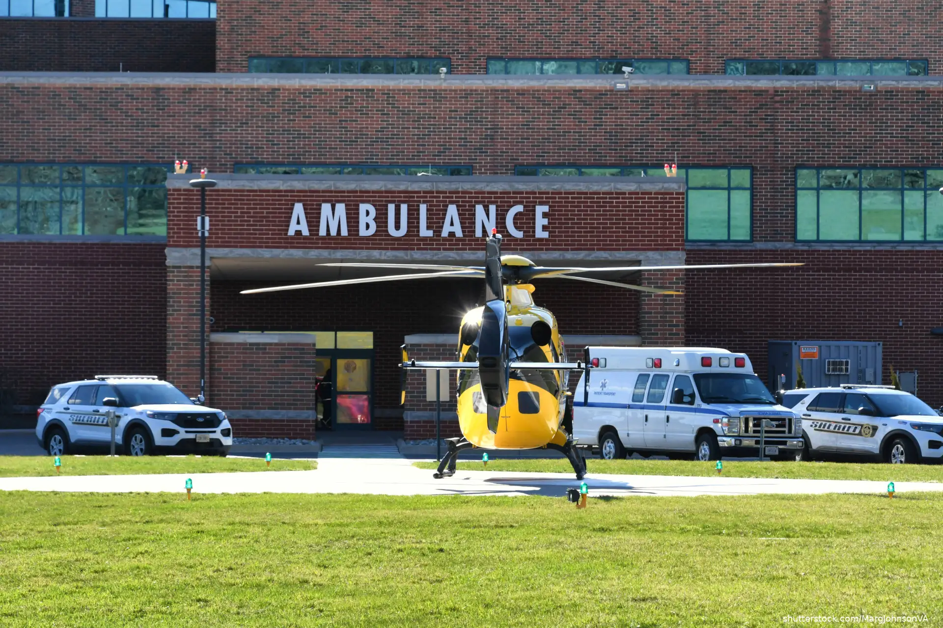 helicopter and ambulances in front of Emergency room entrance