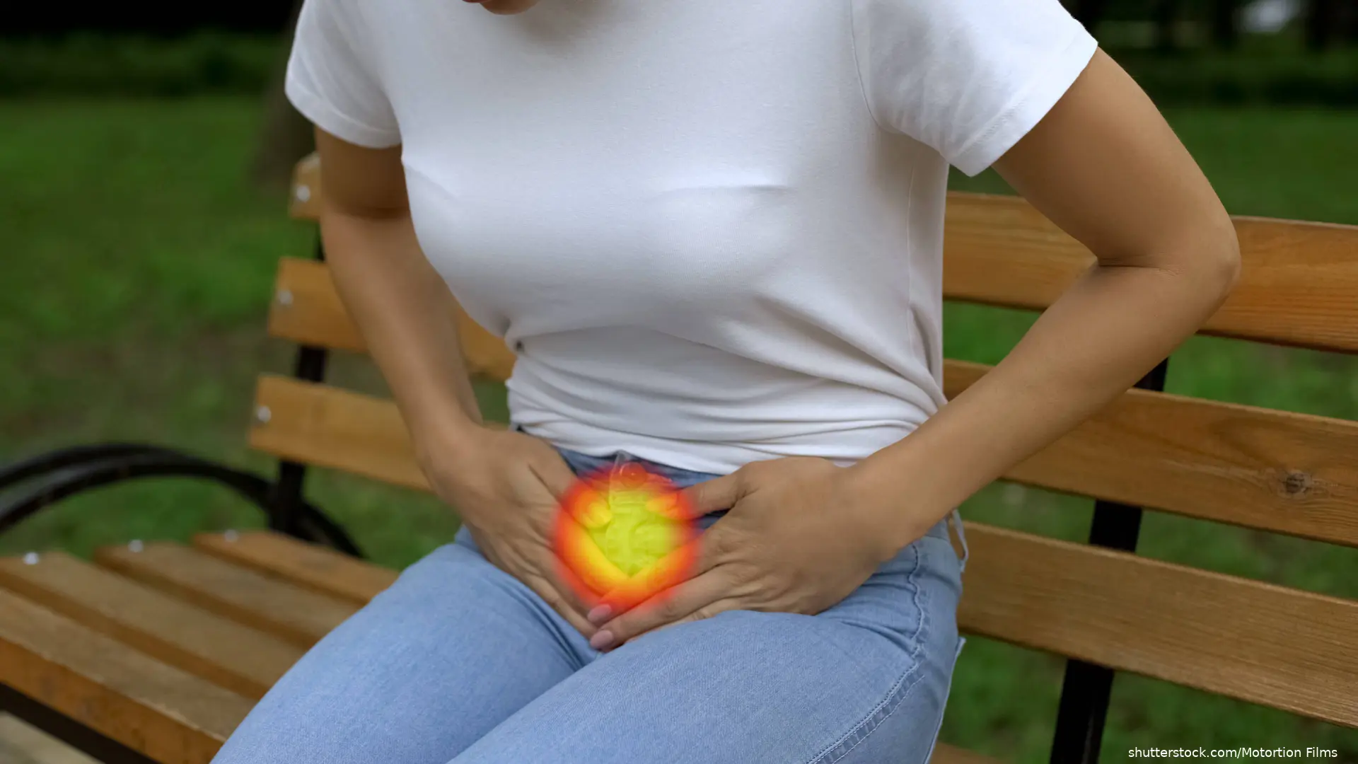 woman holding abdomen indicating pain