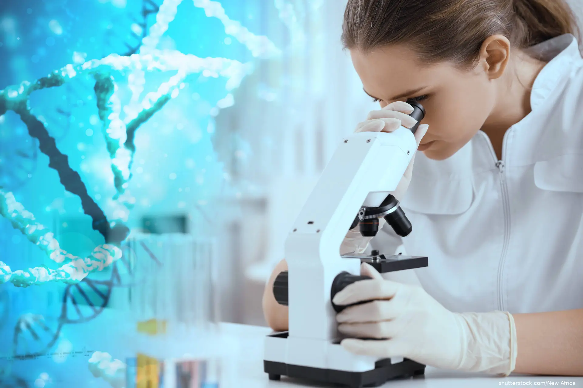 female scientist looking into microscope