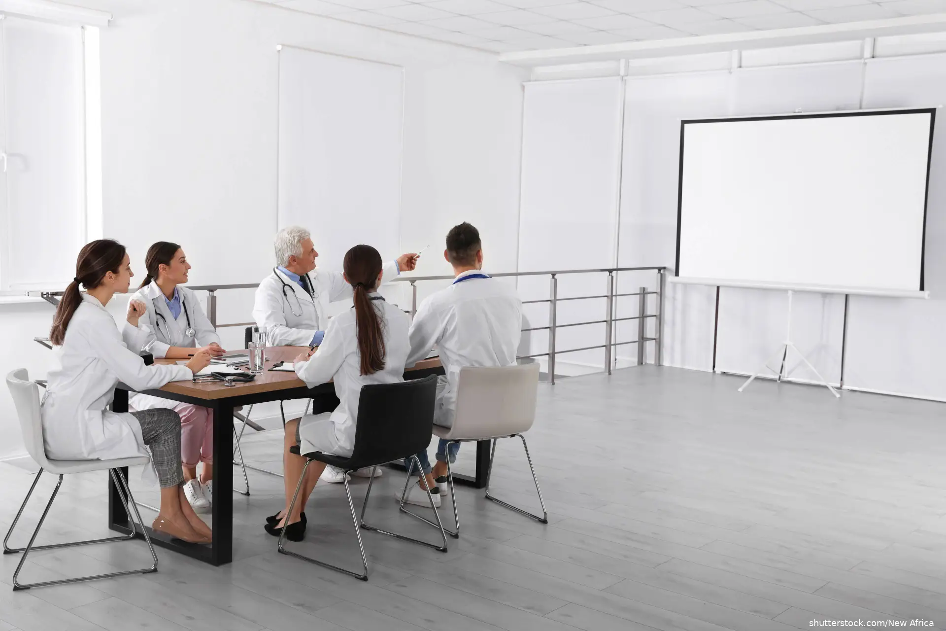 Team of doctors using video projector during conference