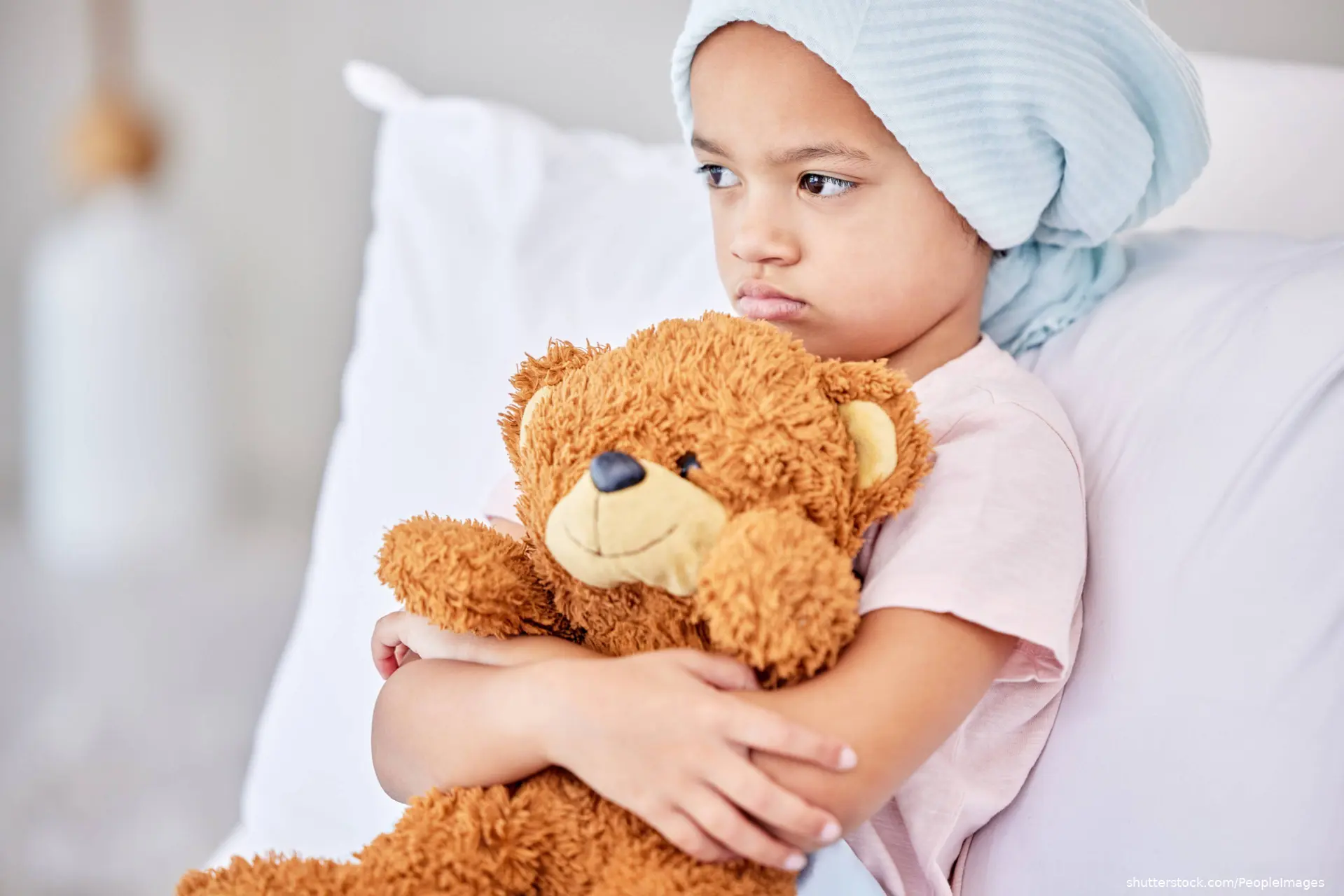 child holding teddy bear