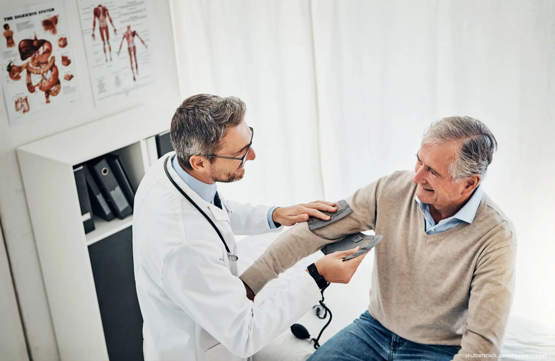doctor taking older male patient's blood pressure