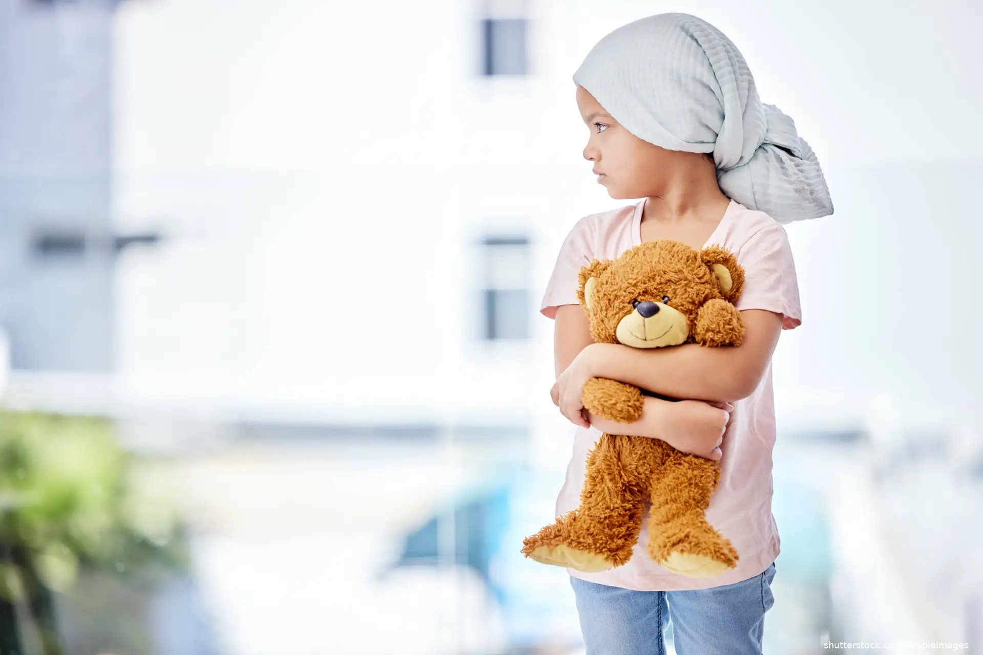 childhood cancer patient holding teddy bear