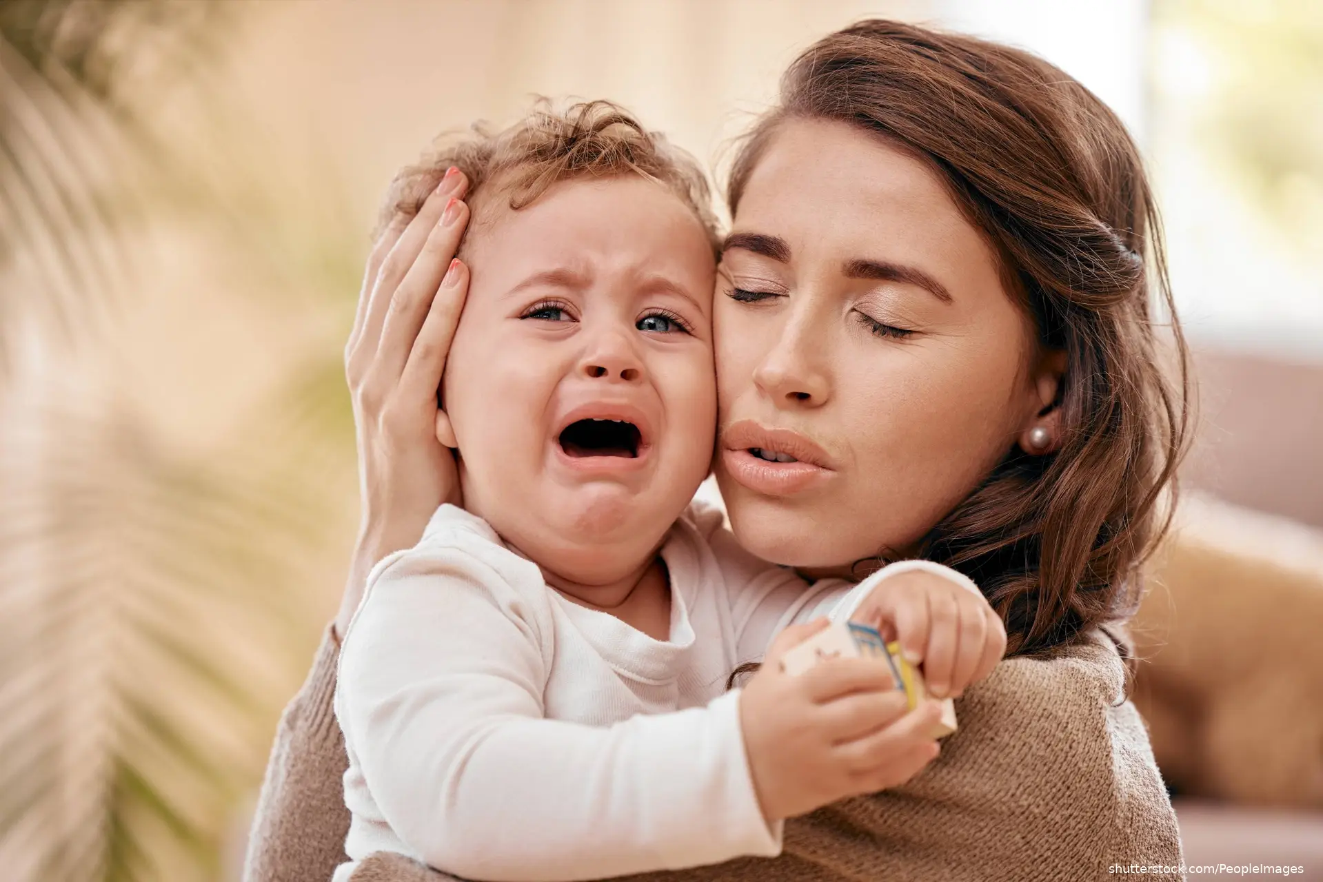 mother comforting crying baby