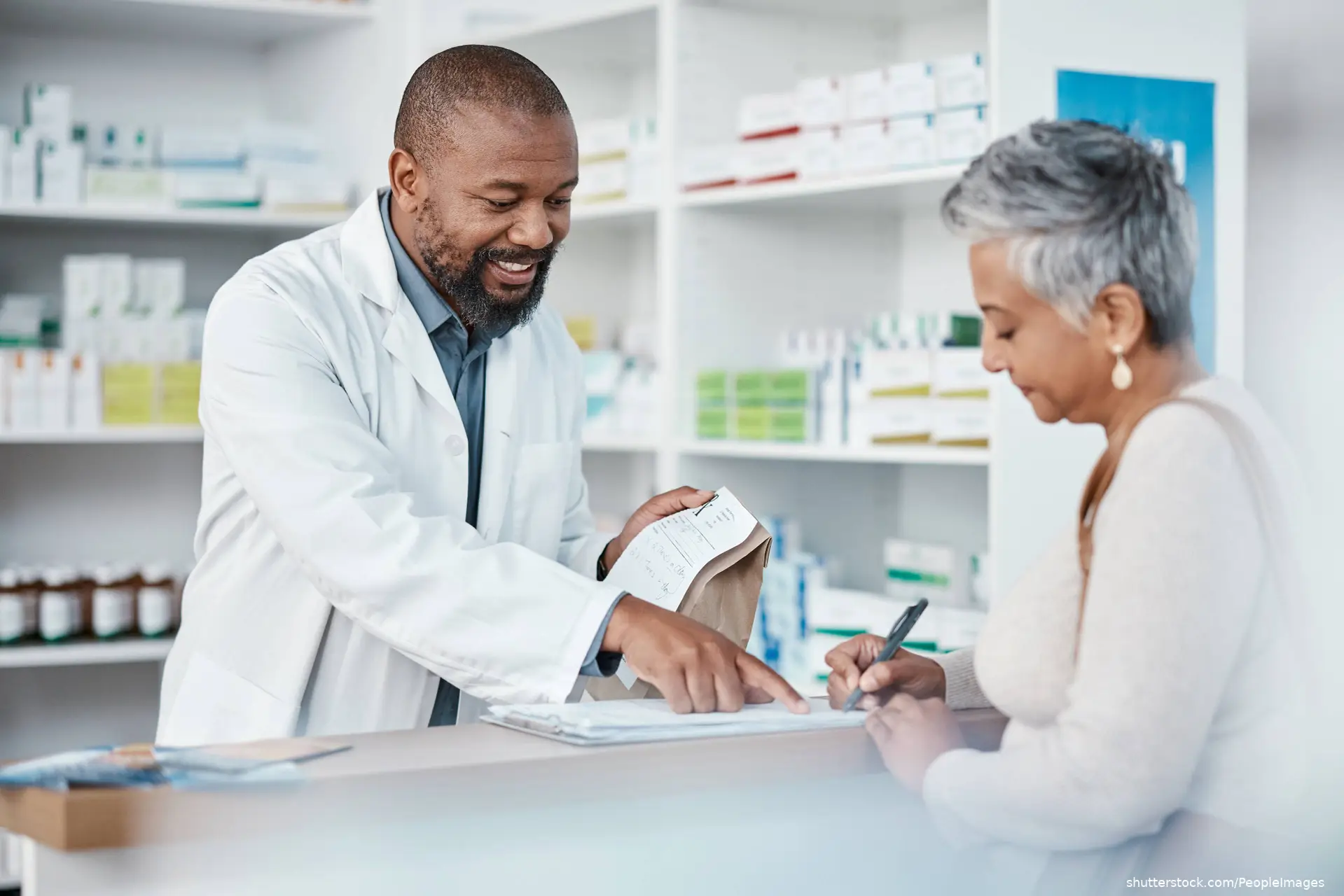pharmacist dispensing medication to a senior woman