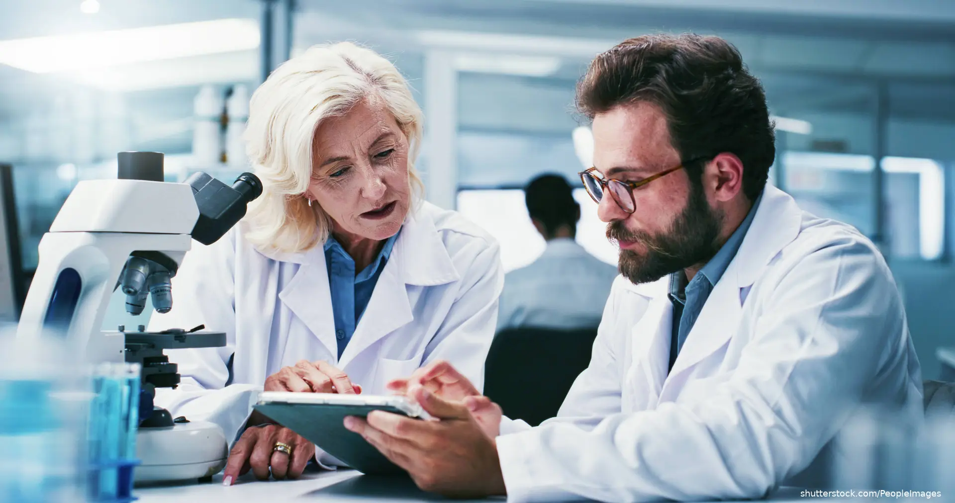 scientists discussing research in lab