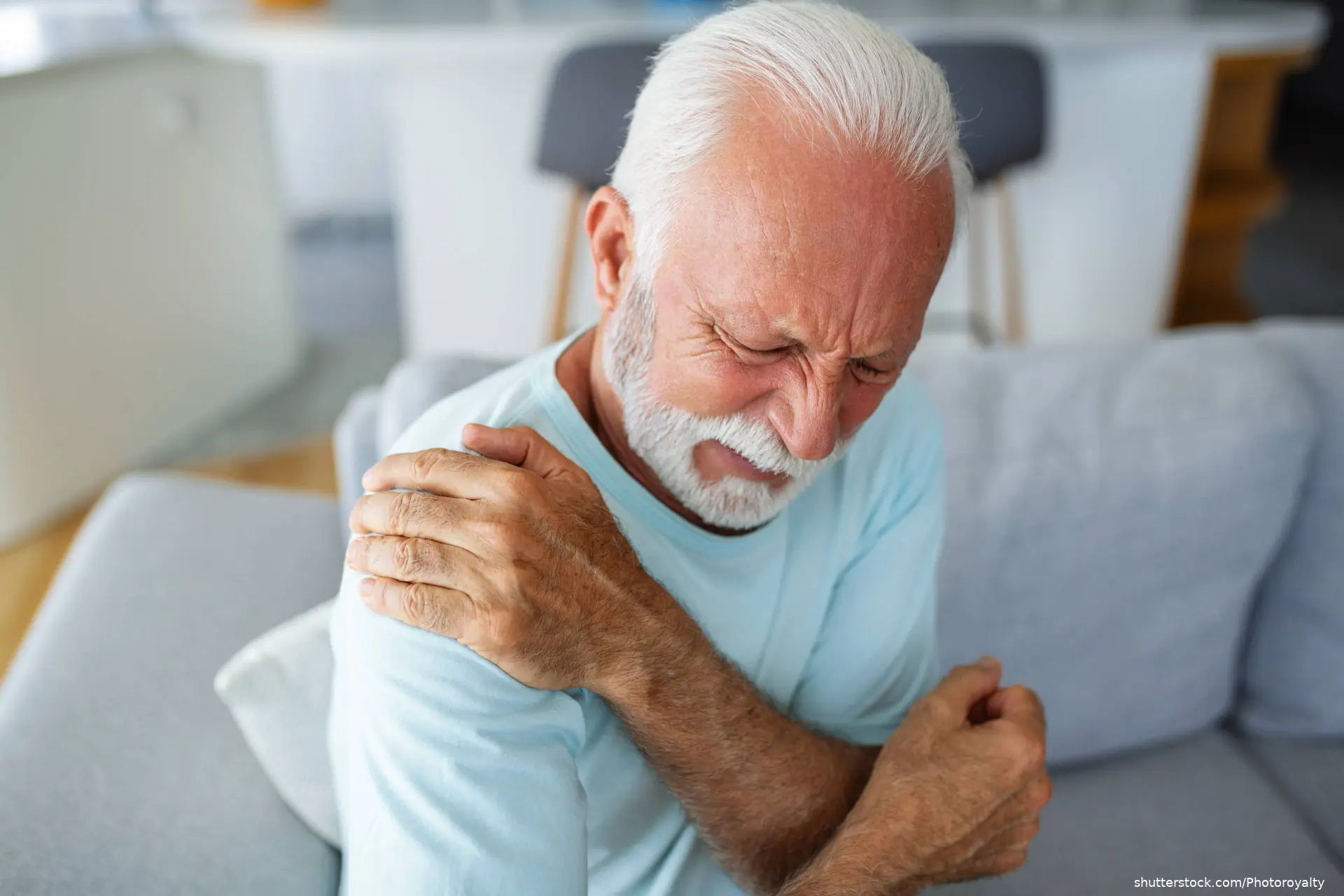 man holding arm in pain