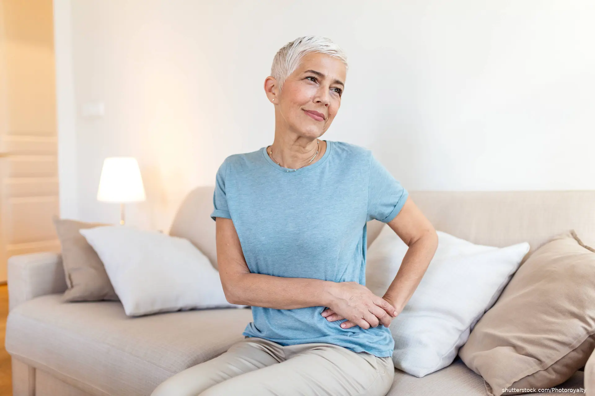 Woman holding her side with kidney pain