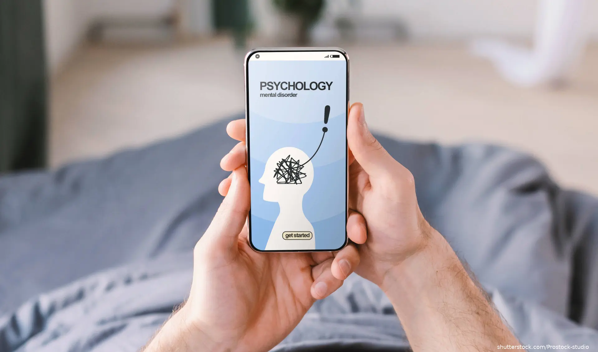 hands holding phone with psychology app opened