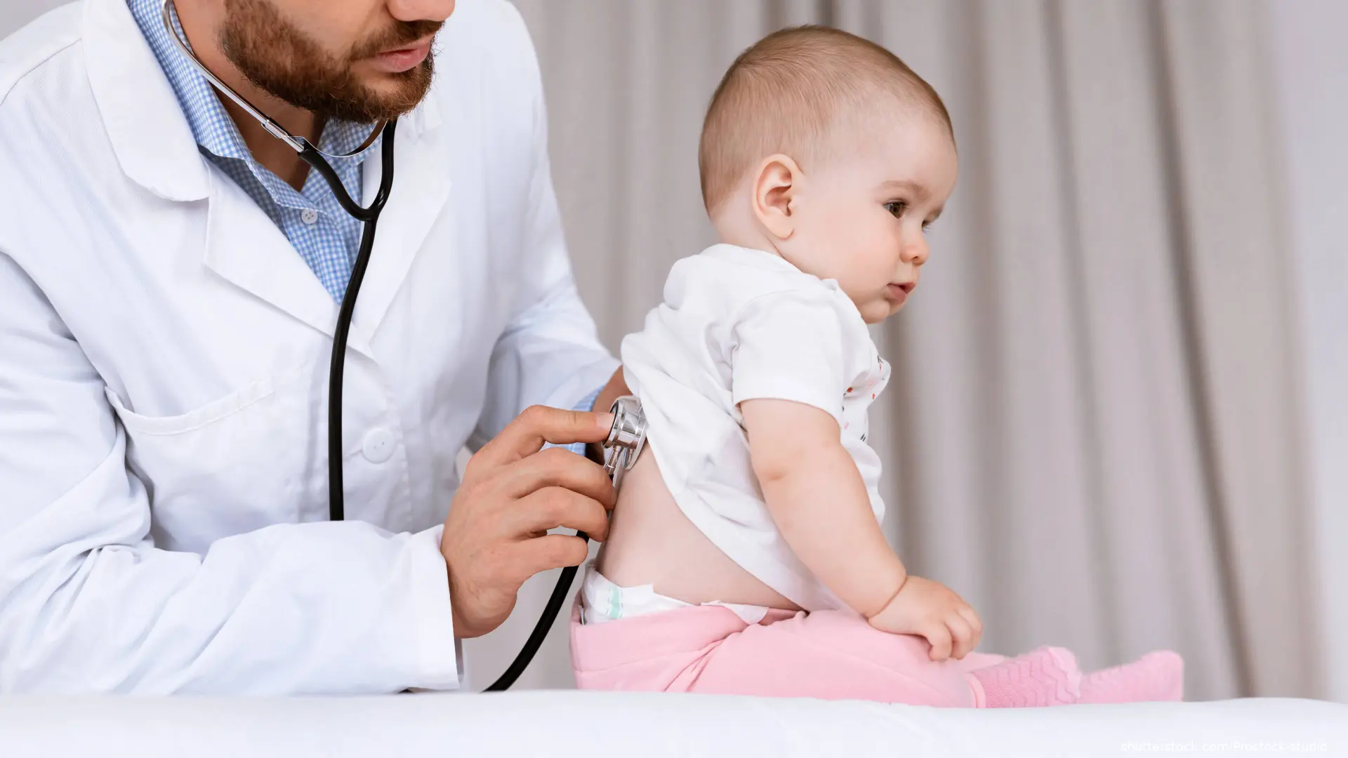doctor listening to infant breathing