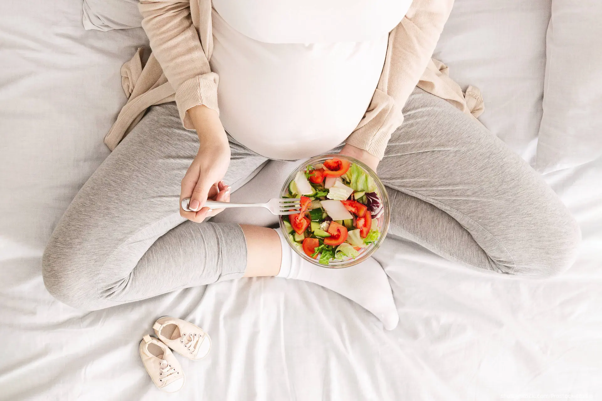 pregnant woman eating salad