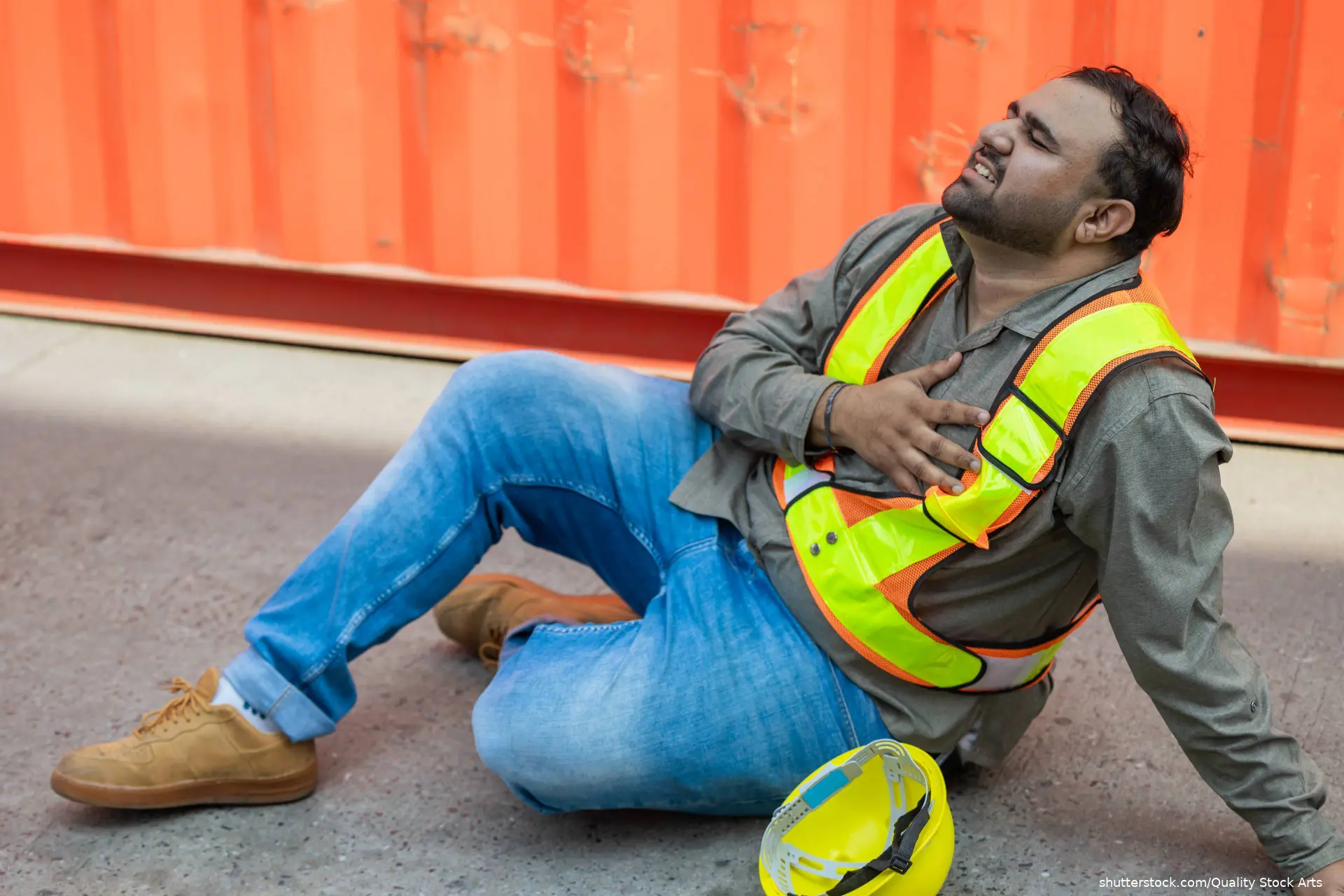 hispanic man on ground holding hand over left chest