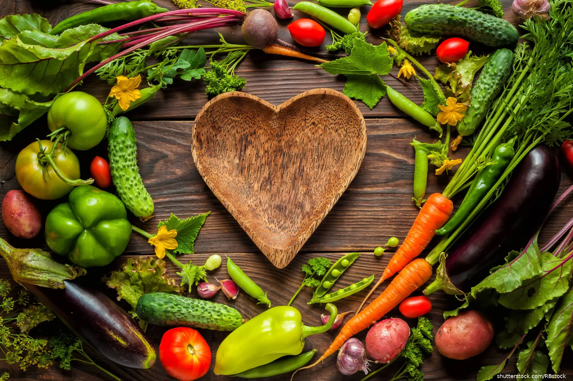 heart shaped plate surrounded by vegetables
