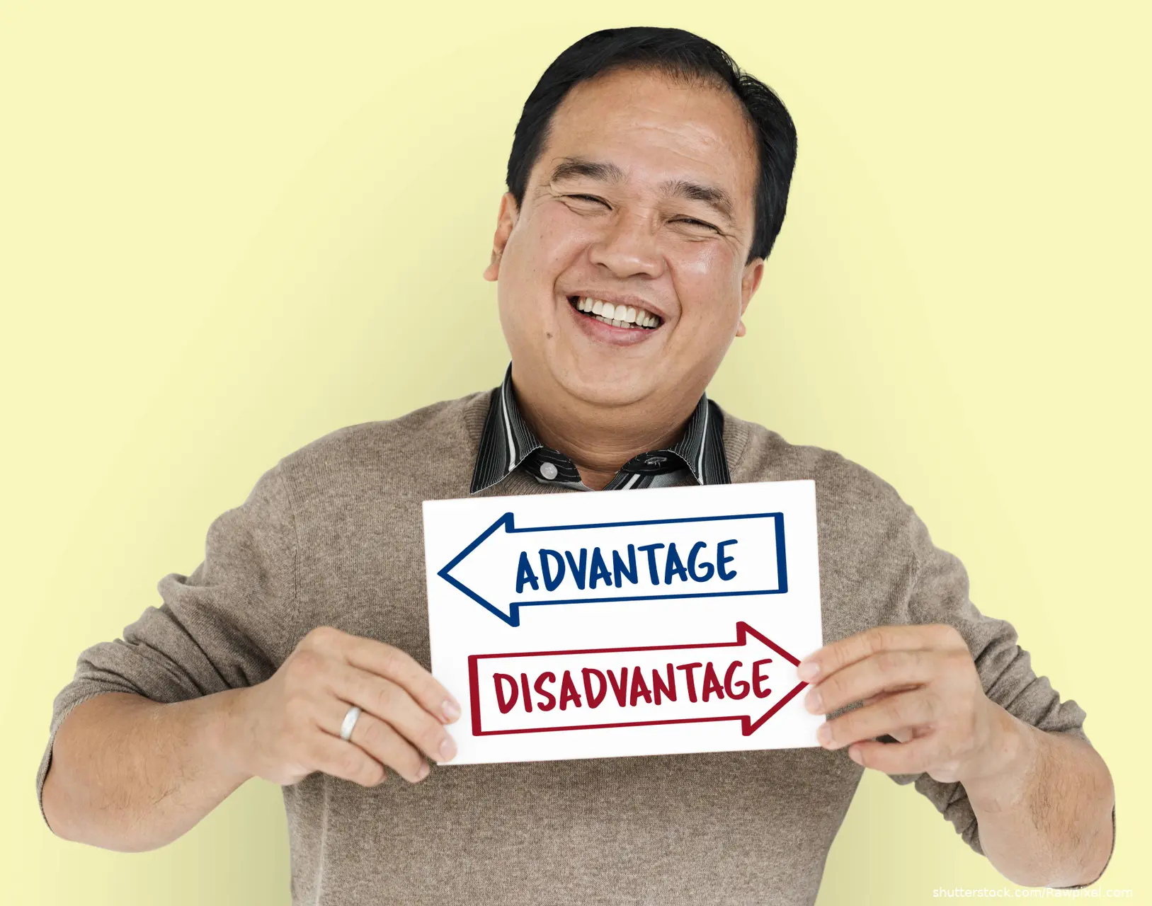 Man holding sign with Arrows facing Opposite  direction stating Advantage Disadvantage