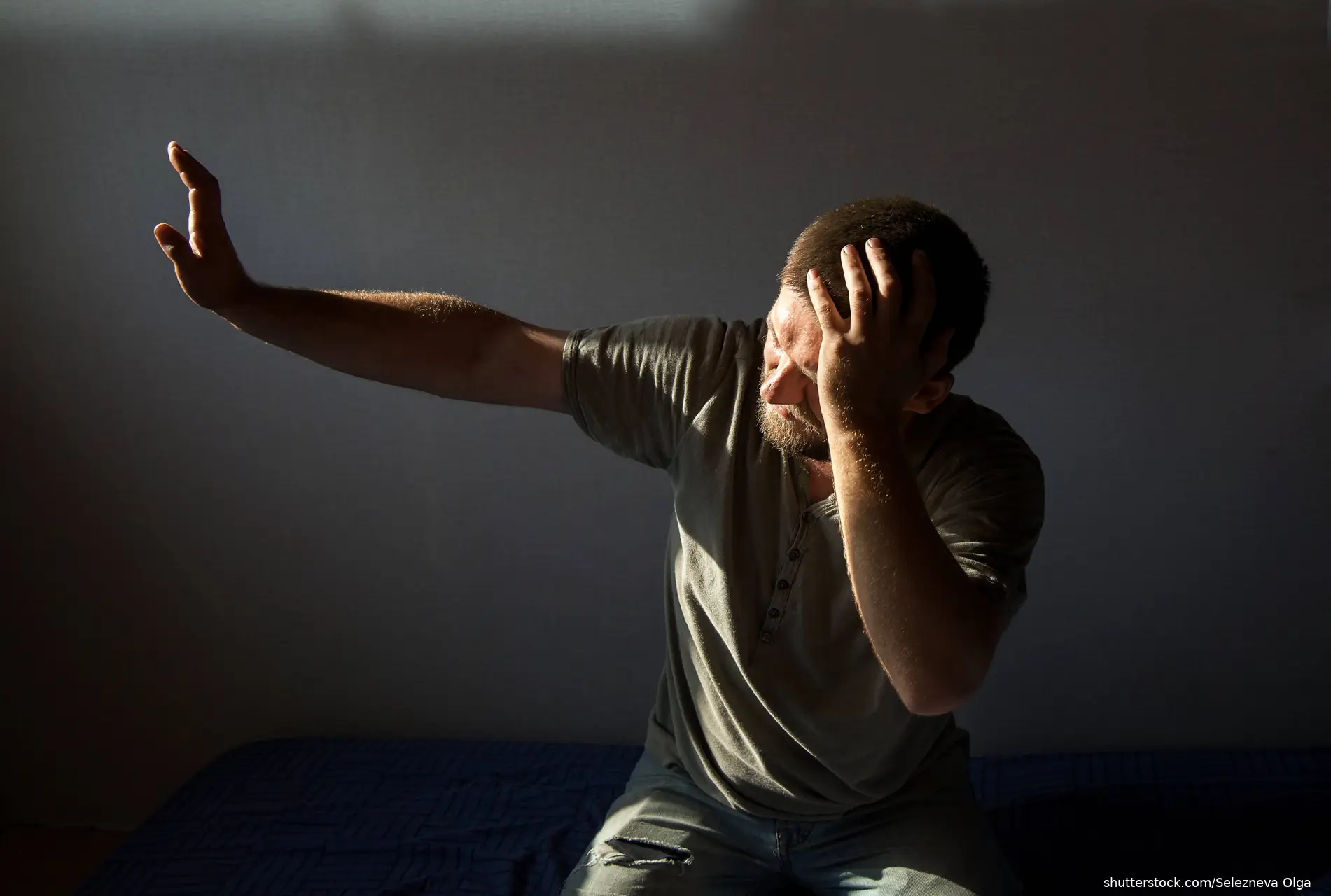 man blocking sunlight with hand