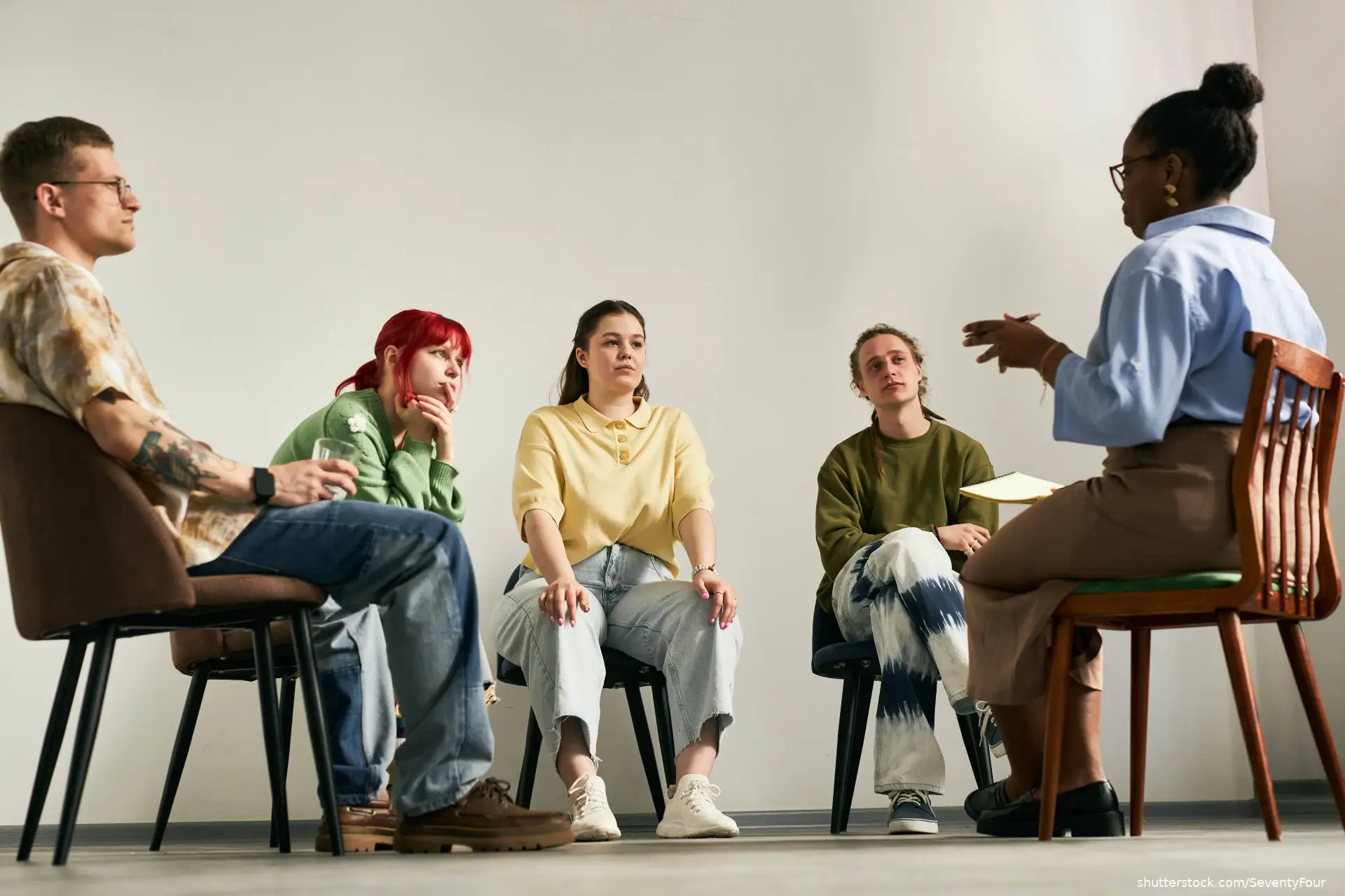 people engaging in group therapy session