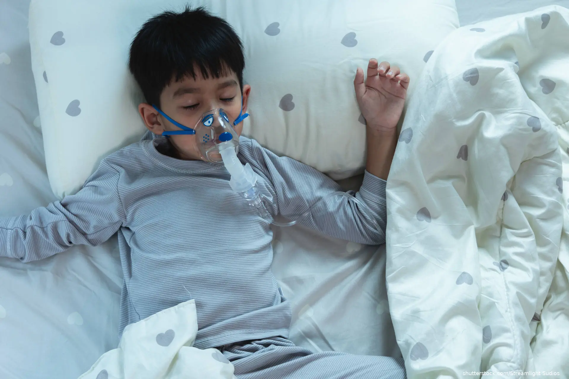 boy in bed with breathing mask
