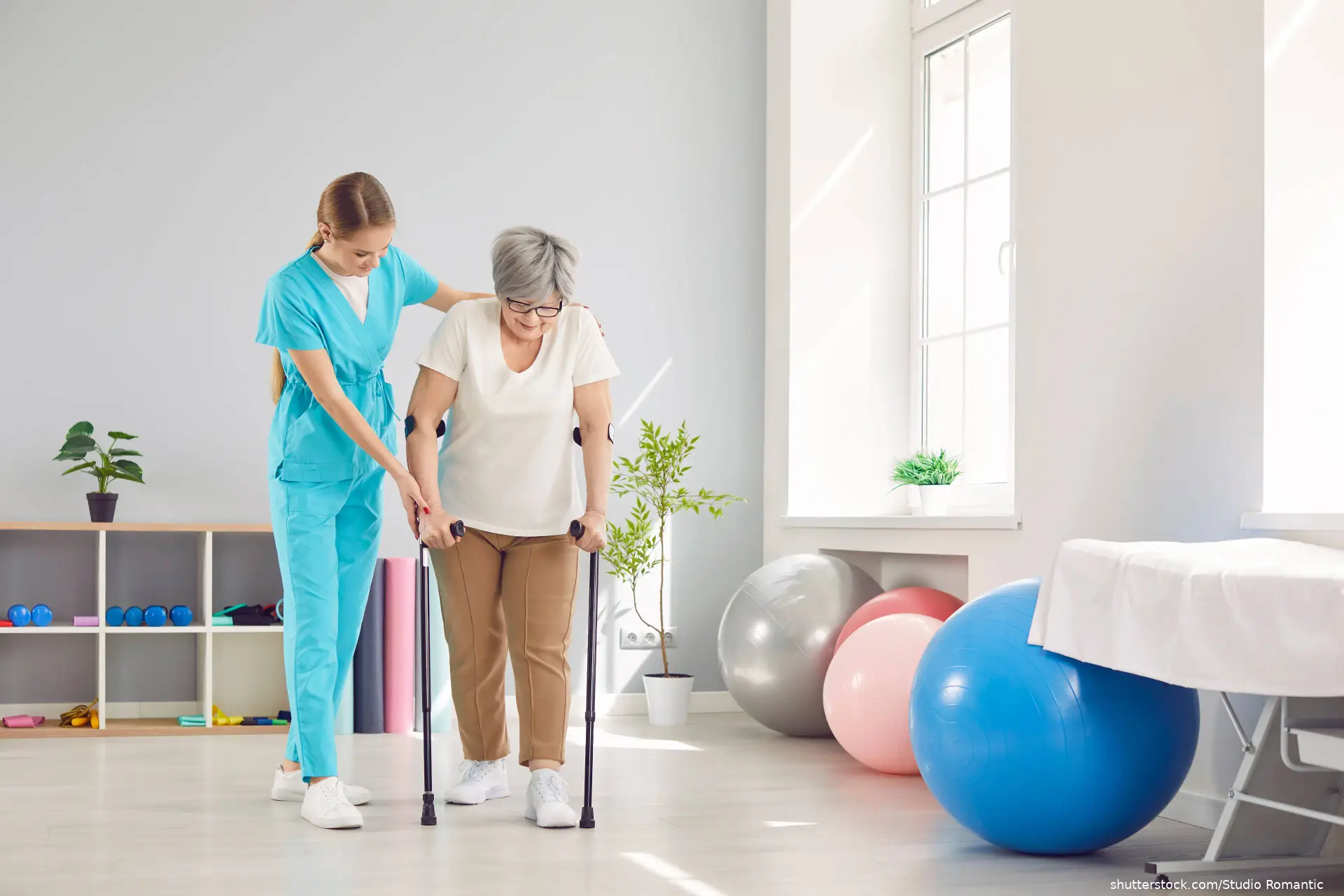 nurse helping elderly woman to walk with crutches