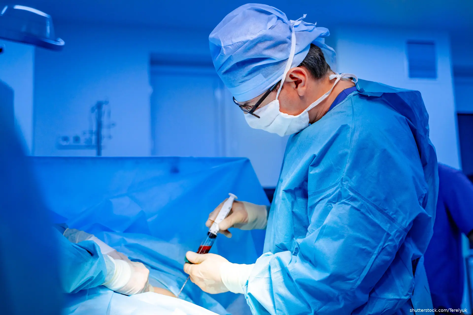 doctor performing bone marrow aspiration