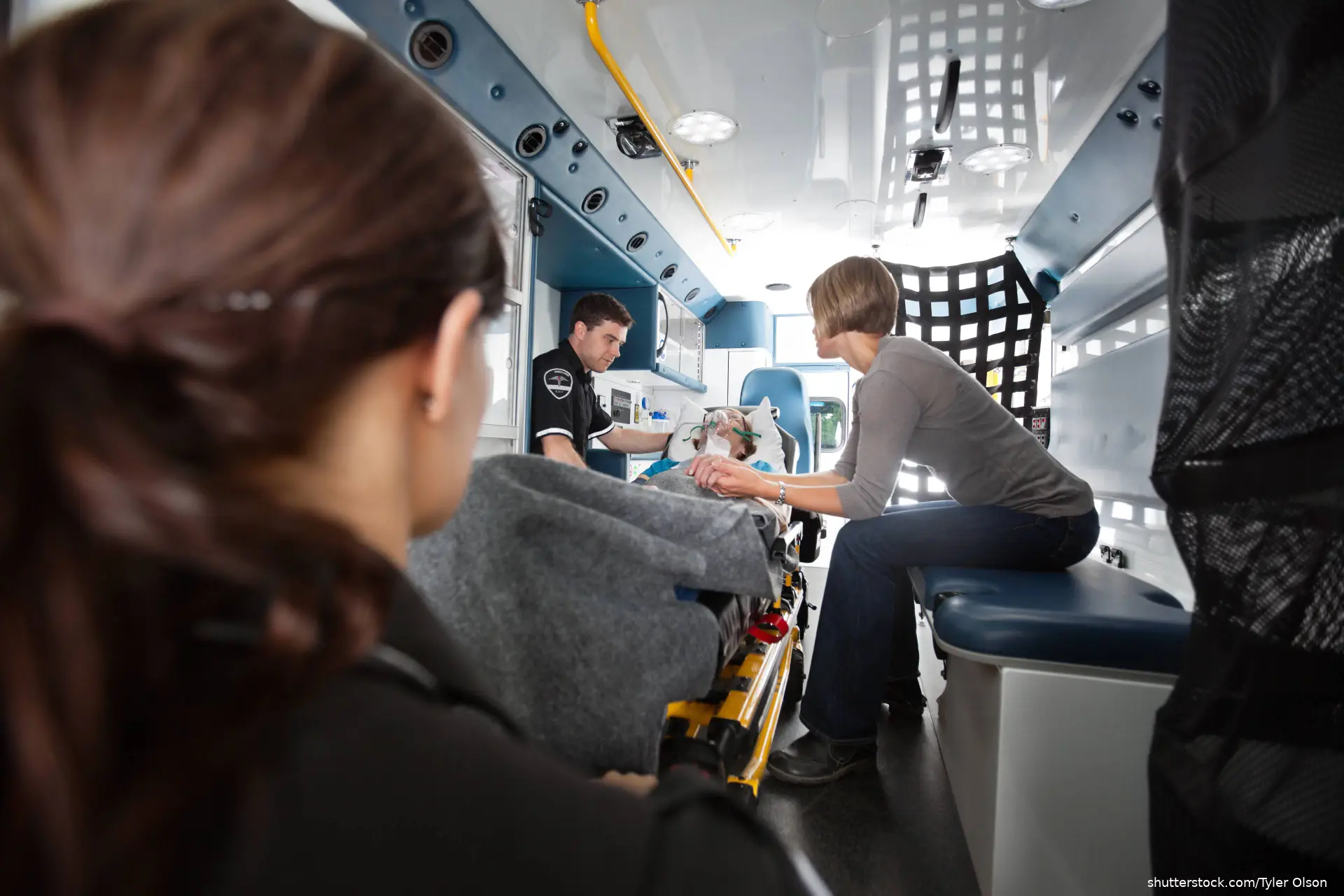 Interior of ambulance with senior woman being transported to hospital
