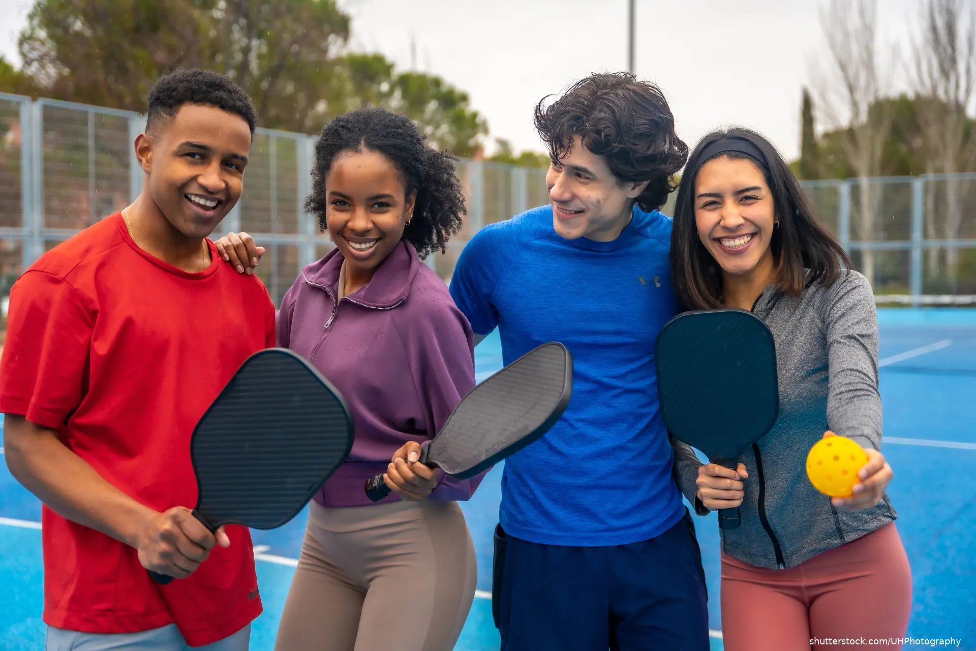 young boys and girls playing paddle tennis
