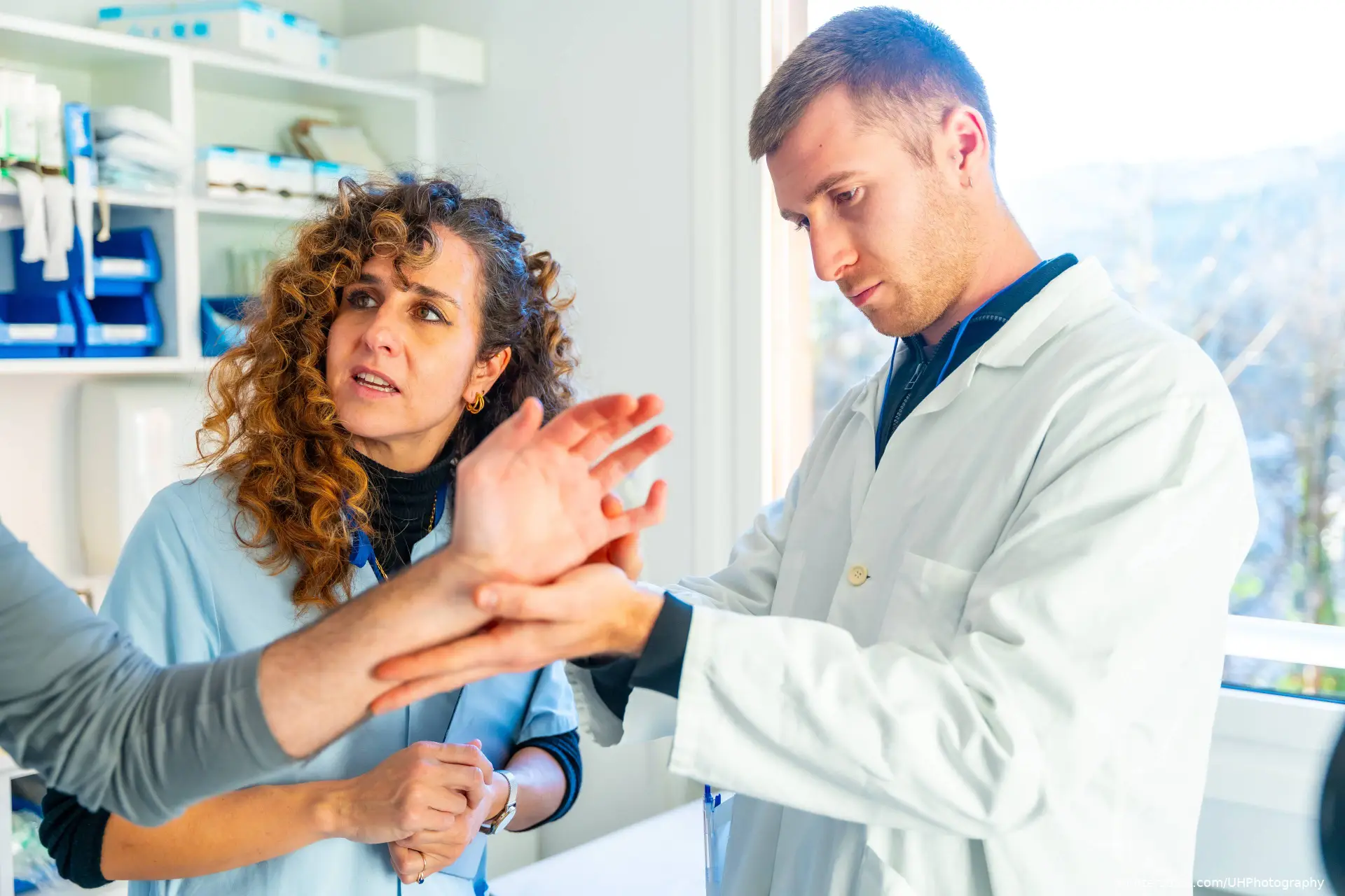 doctor examining patient's hand