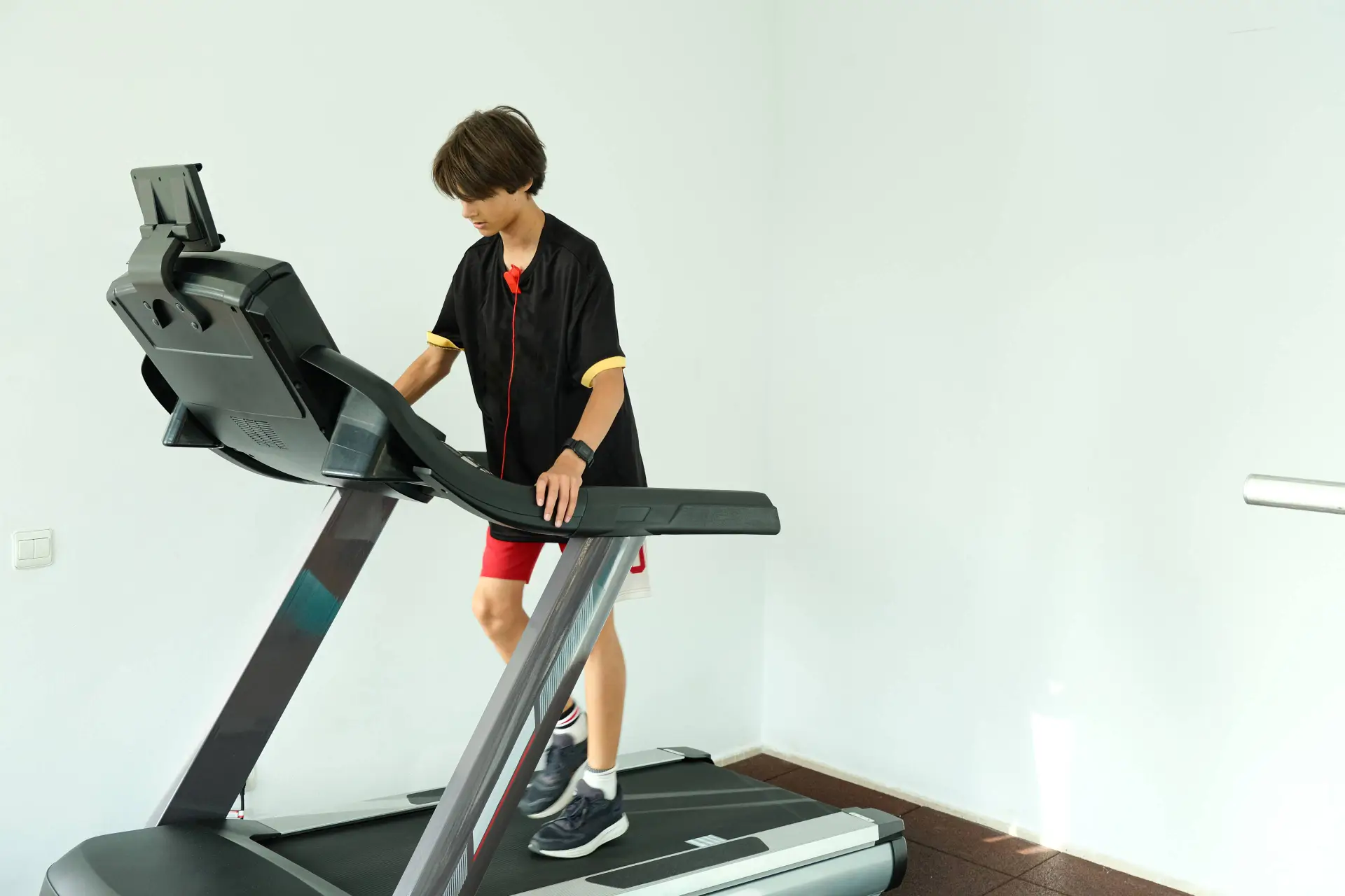 Teenage boy running on treadmill
