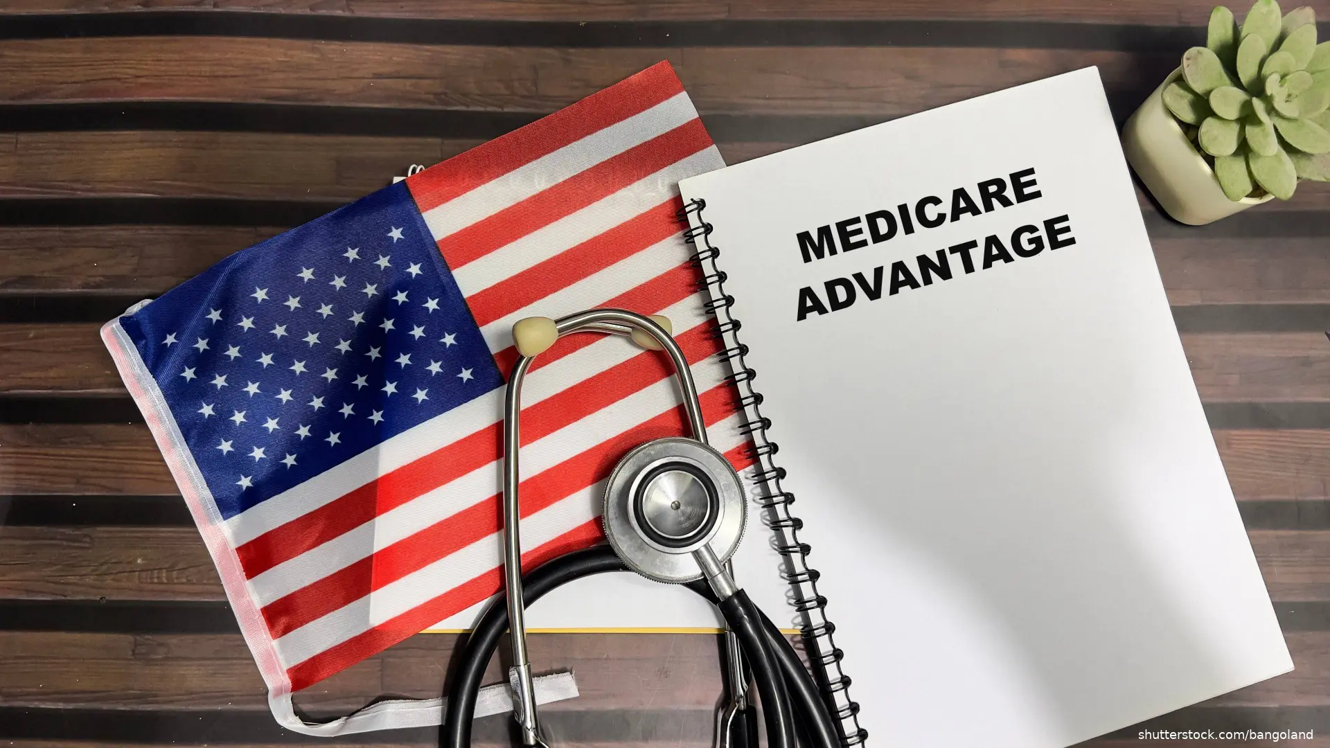 flag, stethoscope and medicare advantage handbook on tables