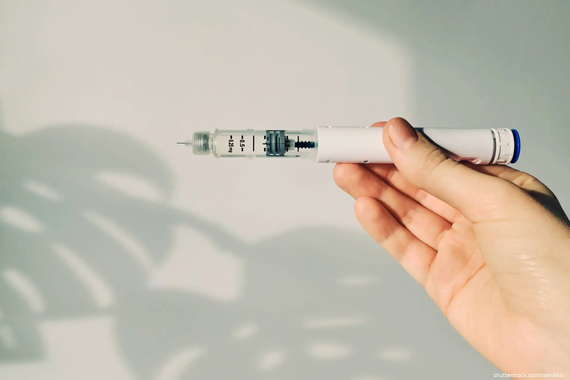 Hand holding GLP-1 injection pen