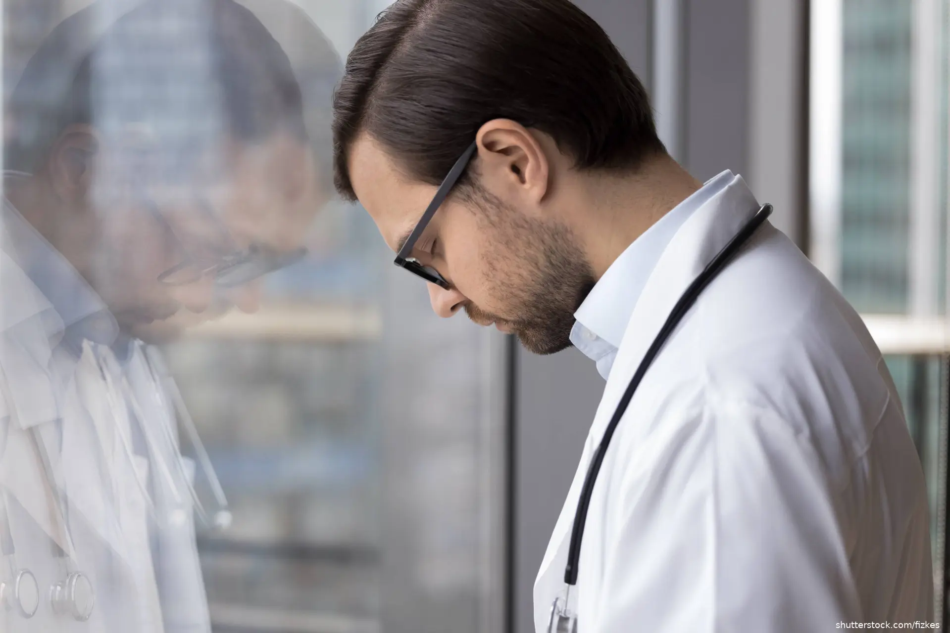 doctor with head down and eyes closed