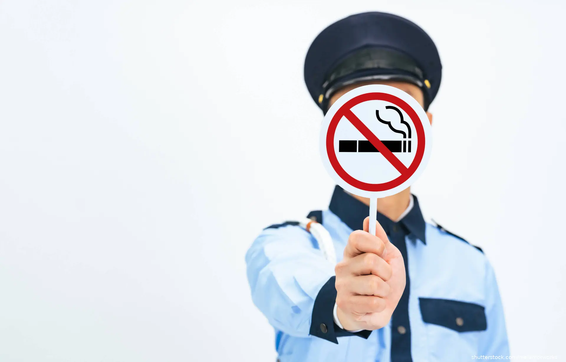 police officer holding no smoking sign