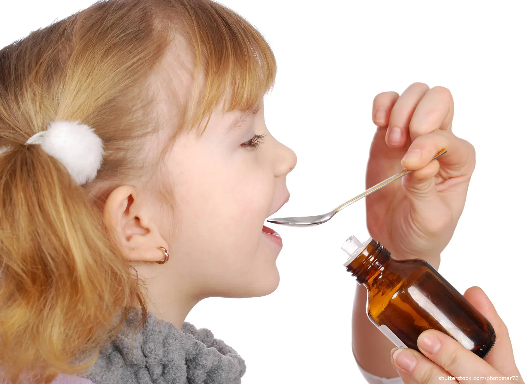 Little girl taking medicine