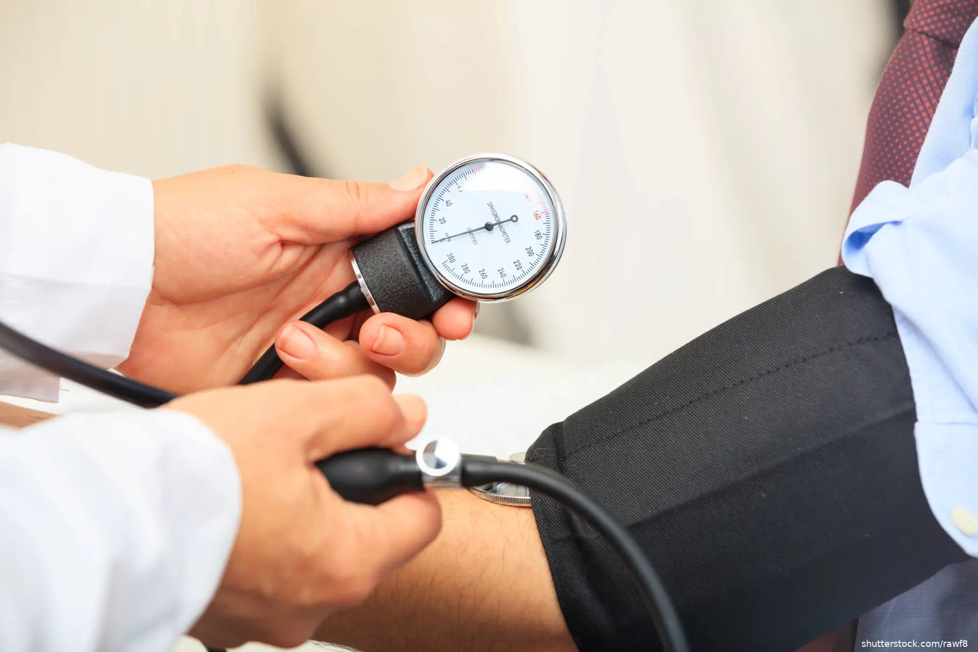 Doctor measuring blood pressure of a patient
