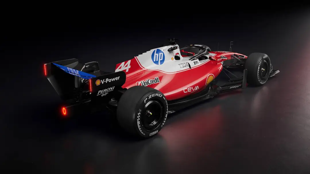 La vista posteriore di tre quarti della Ferrari SF-26, con verniciatura rossa lucida con dettagli bianchi, blu e neri