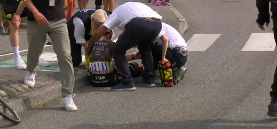 Jonas Vingegaard being cared to on the ground after his fall at the Tour de France