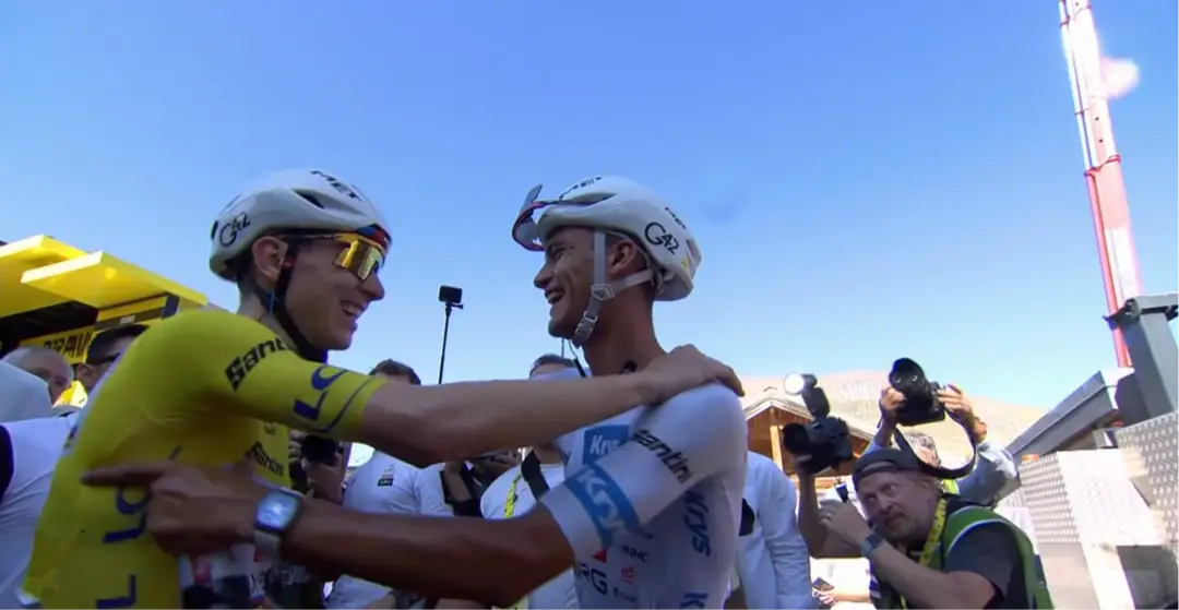 Isaac del Toro congratulates Tadej Pogacar at the finish of stage 19