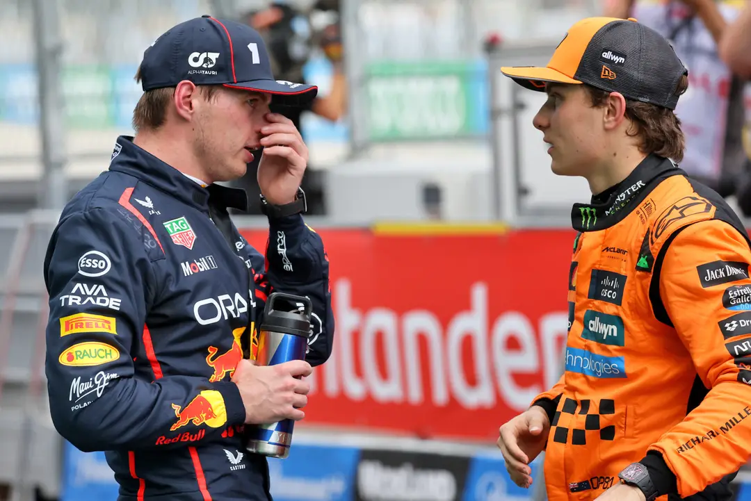 Piastri talking to Max Verstappen after taking pole position at the Spanish GP