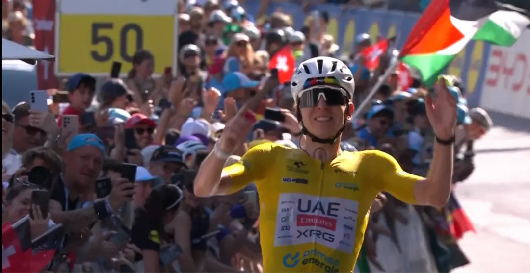 Pogacar reißt die Arme hoch nach dem Gewinn von Etappe 5 und dem Gesamtsieg bei der Ronde van Zwitserland.