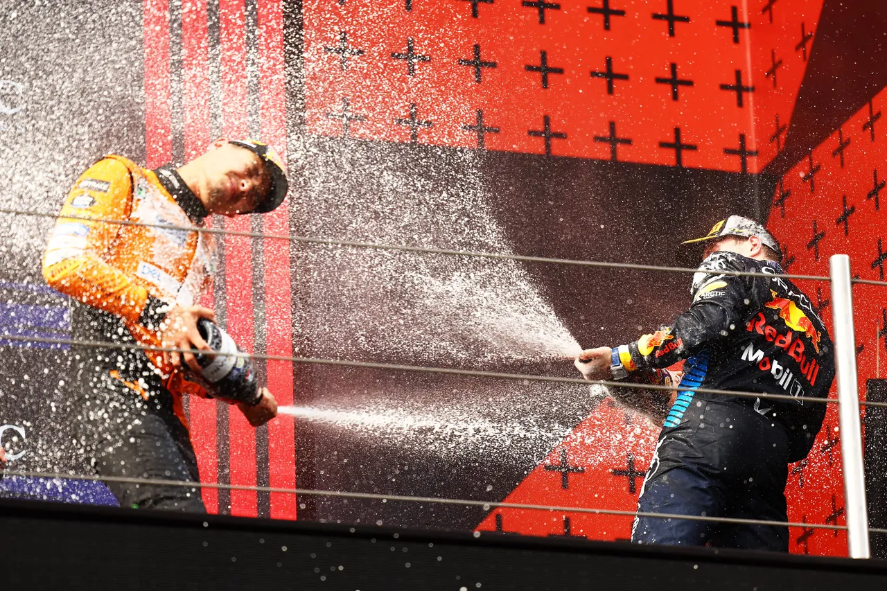 Max Verstappen and Lando Norris on the podium in Imola, 2024.